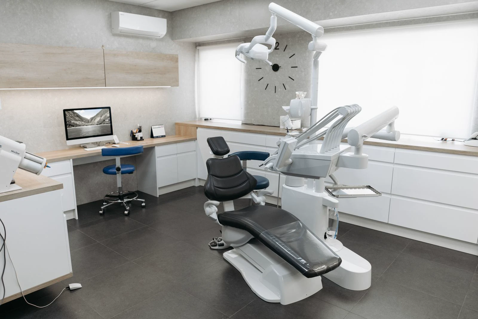 An open dental treatment room with a black dental chair and equipment. Illustrative stock photo, not Lincoln Dental premises.